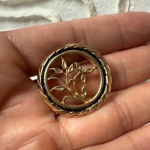 vintage gold-tone filigree leaf brooch black circular accent braided gold edge